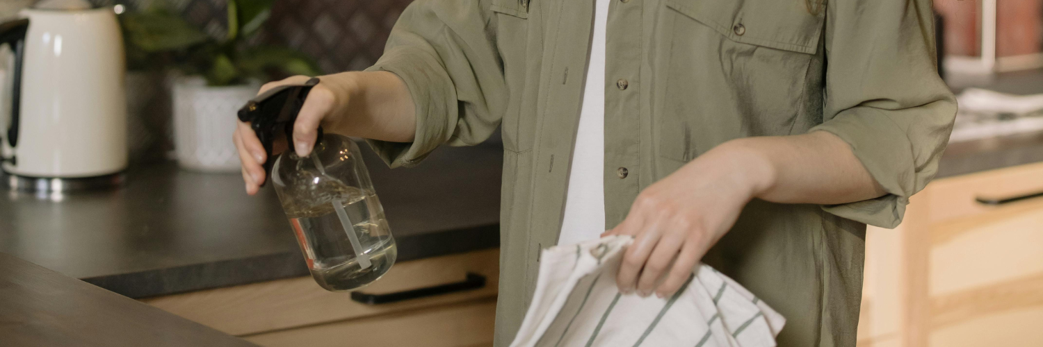 women cleaning with spray bottle 